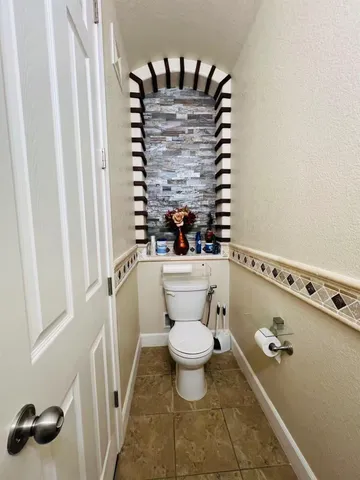 a view of bathroom with a sink and mirror