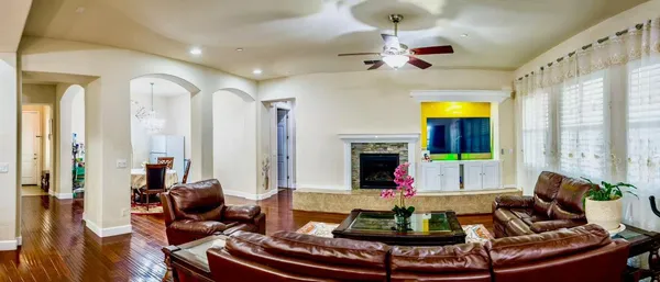 a living room with fireplace furniture and a large window