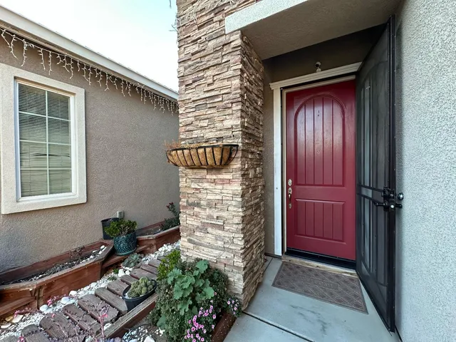 a front view of a house with a red gate