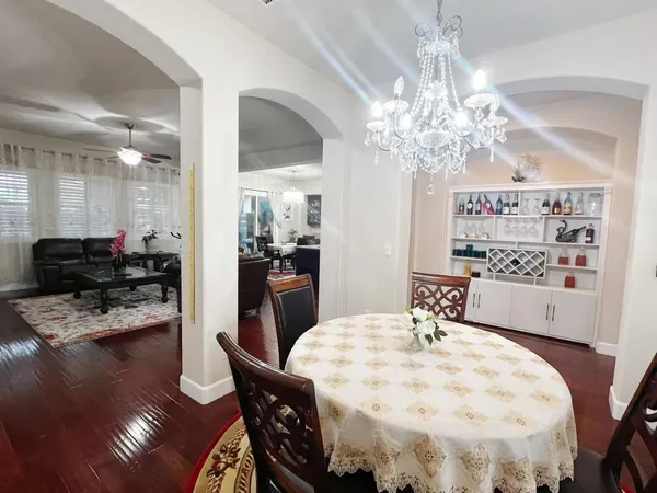 a view of a dining room with furniture and wooden floor