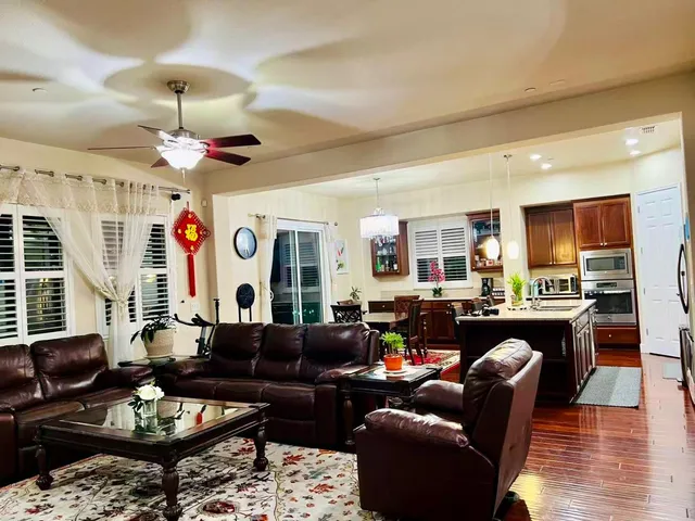 a living room with furniture a dining table and a fireplace
