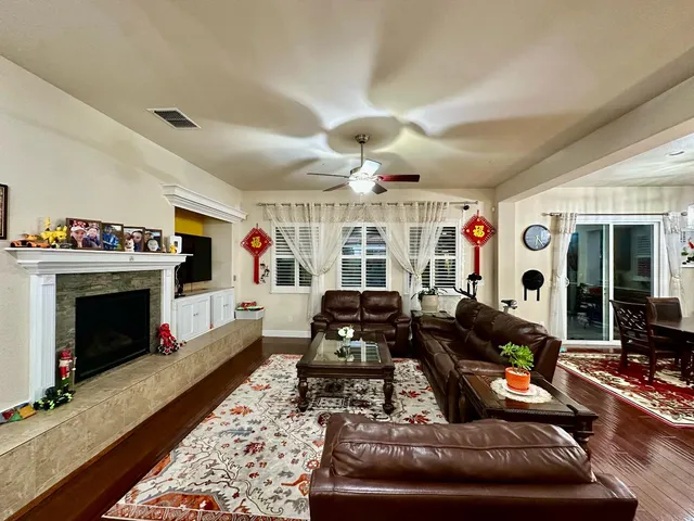 a living room with furniture fireplace and a flat screen tv