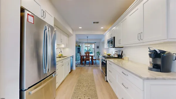 a bathroom with a sink a toilet and a shower