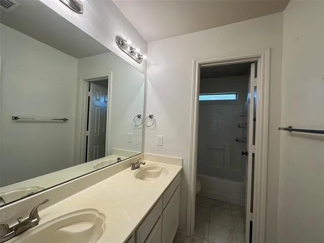 a view of a livingroom with a ceiling fan and window