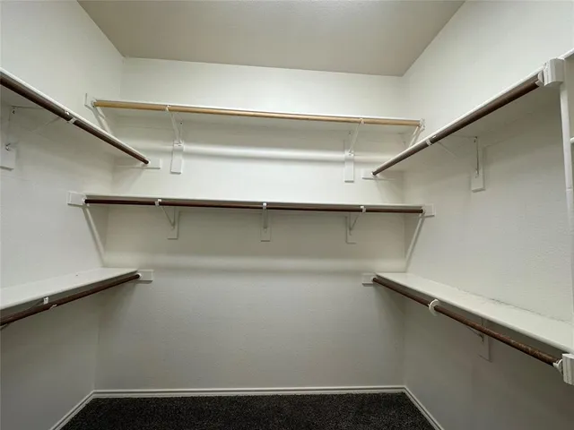 a view of a lake with a yard and a large trees