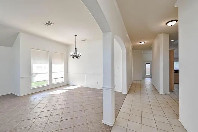 a view of a hallway with a chandelier