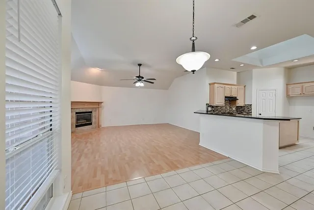 a view of a kitchen with microwave and cabinets