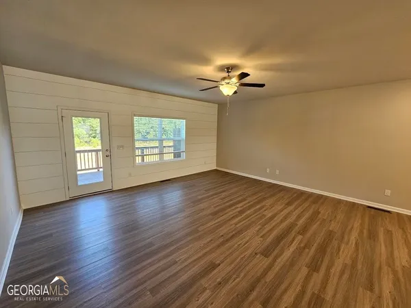 a large kitchen with a large window and stainless steel appliances