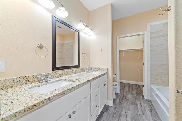 a bathroom with a granite countertop sink mirror and