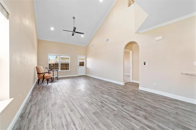 a view of a room with wooden floor and dining room