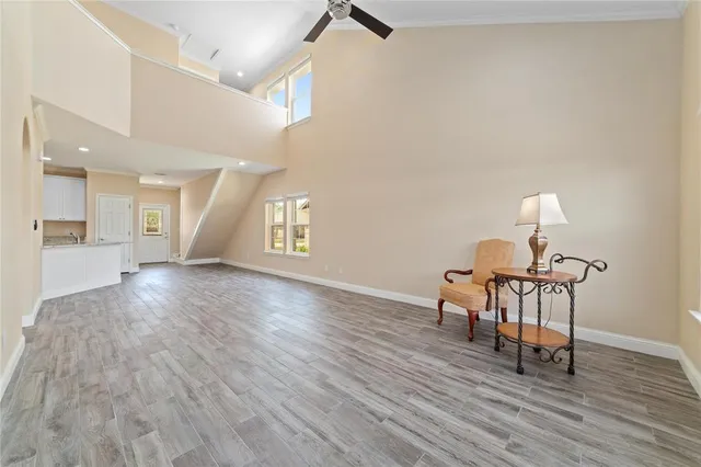 a view of a livingroom with furniture wooden floor and a window