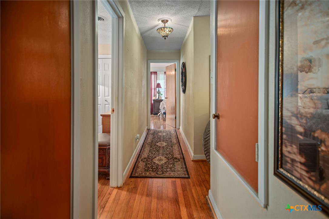 218 Burnet Street Port Lavaca, TX 77979 - Photo 11 of 23 a view of a hallway view with wooden floor and living room