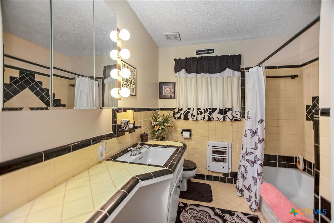 218 Burnet Street Port Lavaca, TX 77979 - Photo 13 of 23 a bathroom with a sink and a mirror