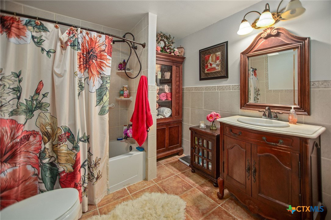 218 Burnet Street Port Lavaca, TX 77979 - Photo 19 of 23 a bathroom with a sink vanity mirror and a toilet
