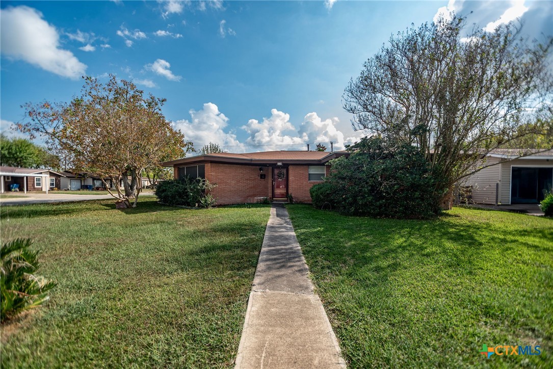 218 Burnet Street Port Lavaca, TX 77979 - Photo 20 of 23 a front view of a house with a garden and trees