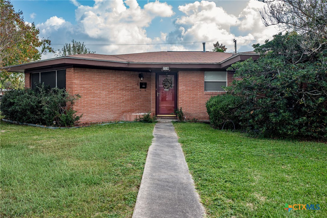 218 Burnet Street Port Lavaca, TX 77979 - Photo 2 of 23 a front view of a house with a garden and plants