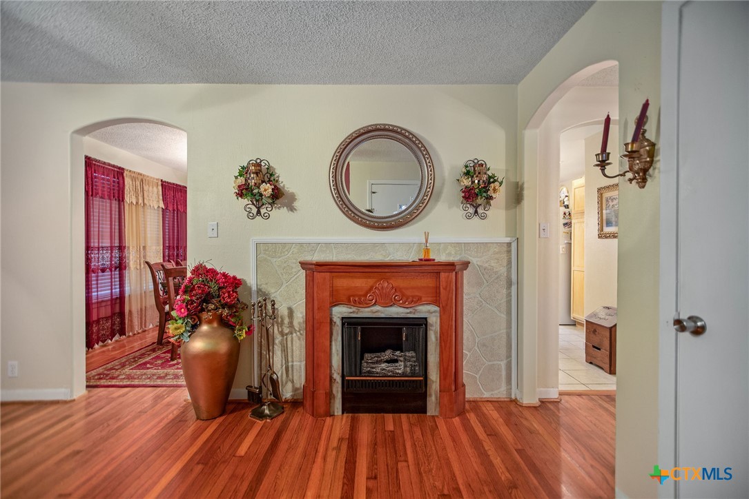 218 Burnet Street Port Lavaca, TX 77979 - Photo 4 of 23 a view of a livingroom with wooden floor and a fireplace