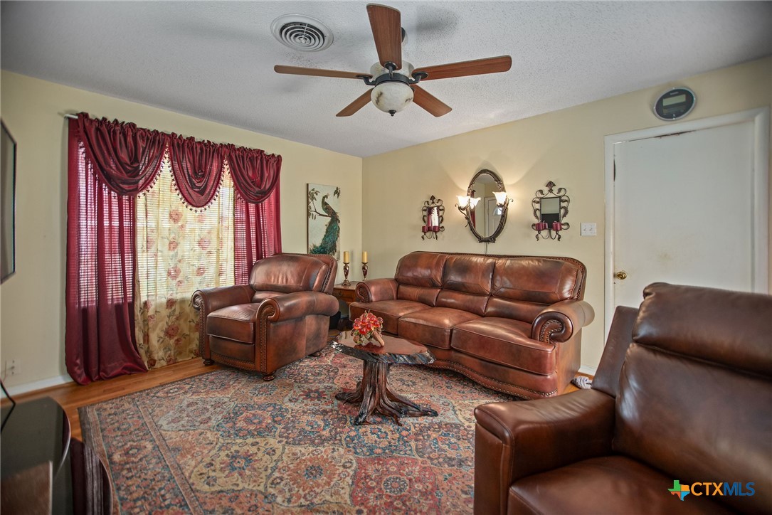 218 Burnet Street Port Lavaca, TX 77979 - Photo 9 of 23 a living room with furniture ceiling fan and a window