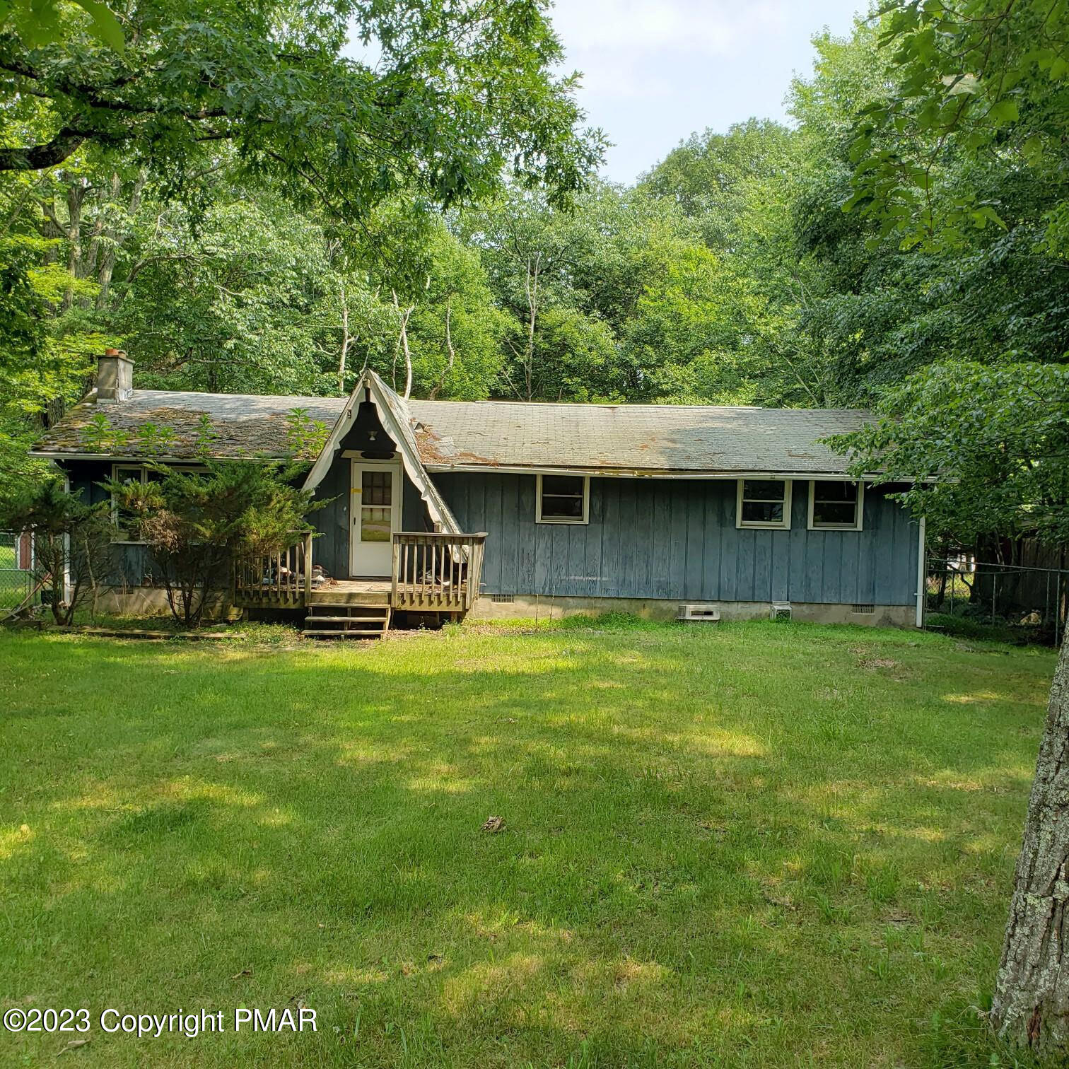 a view of a house with a backyard and a patio