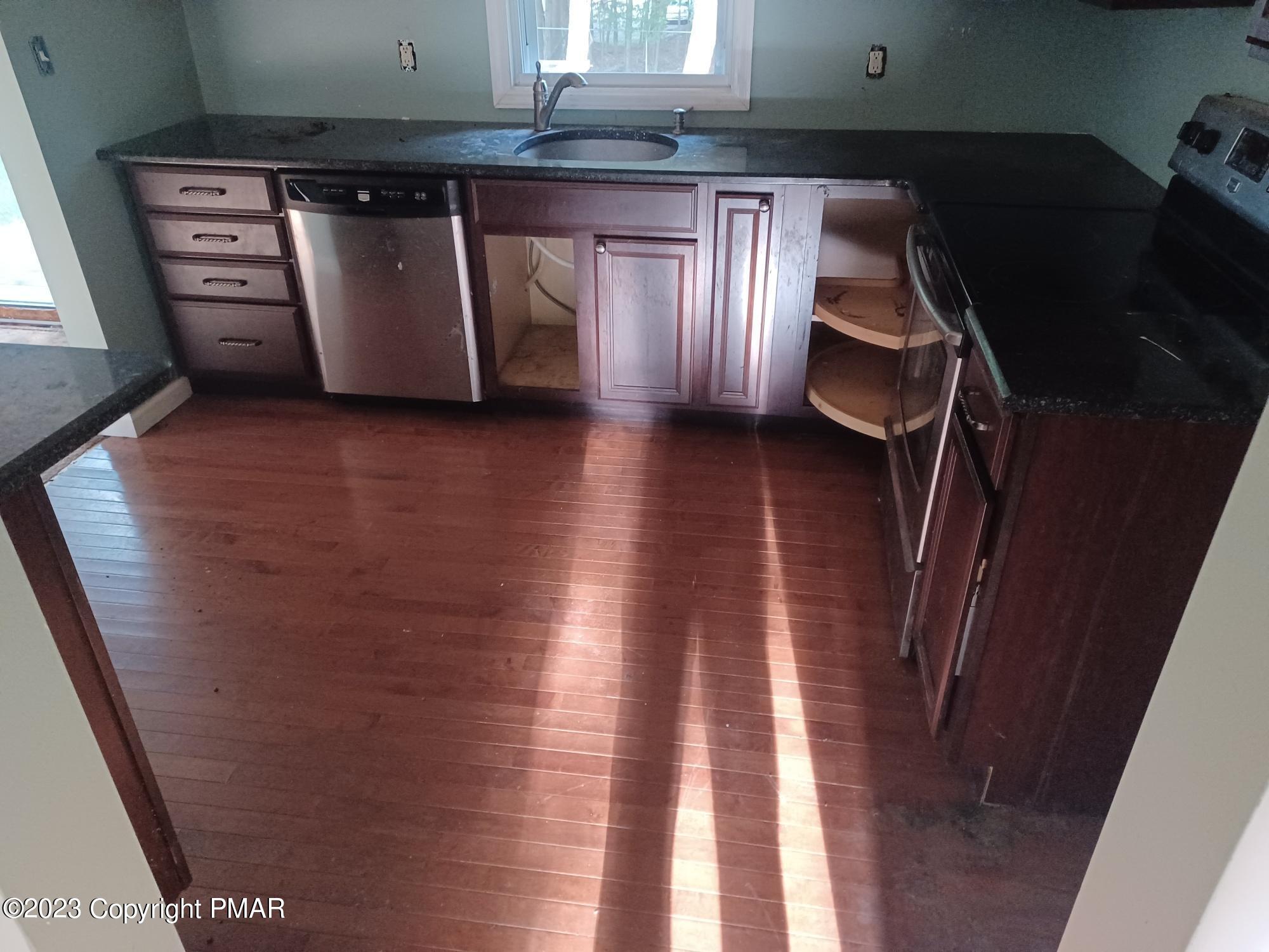 166 Skyview Road Dingmans Ferry, PA 18328 - Photo 4 of 7 a kitchen with stainless steel appliances granite countertop a refrigerator and a stove