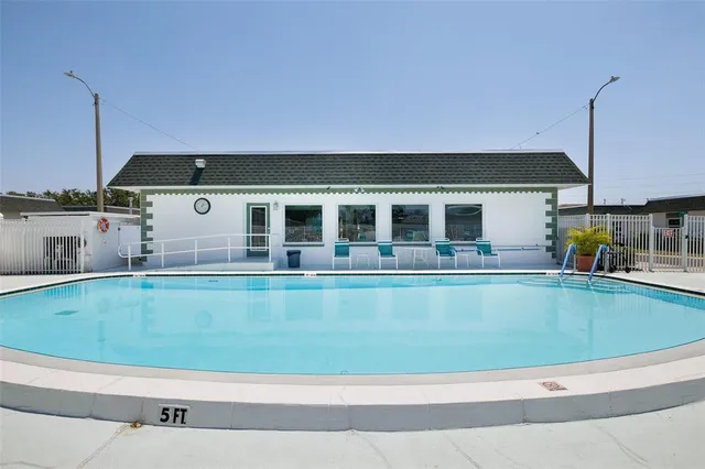 a view of a swimming pool with a lounge chair