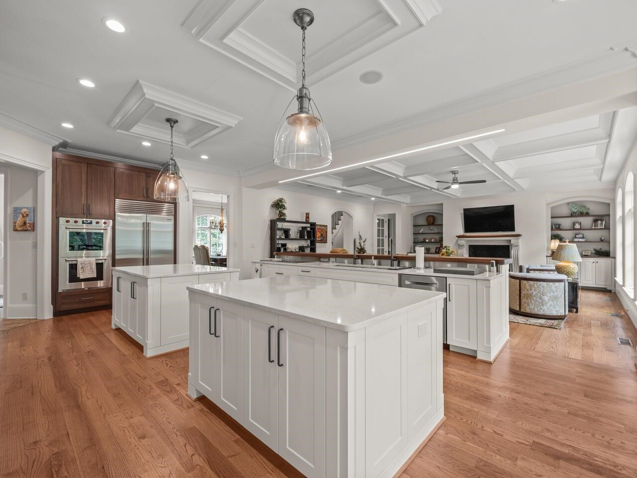 a large kitchen with kitchen island a sink a counter top stainless steel appliances and cabinets