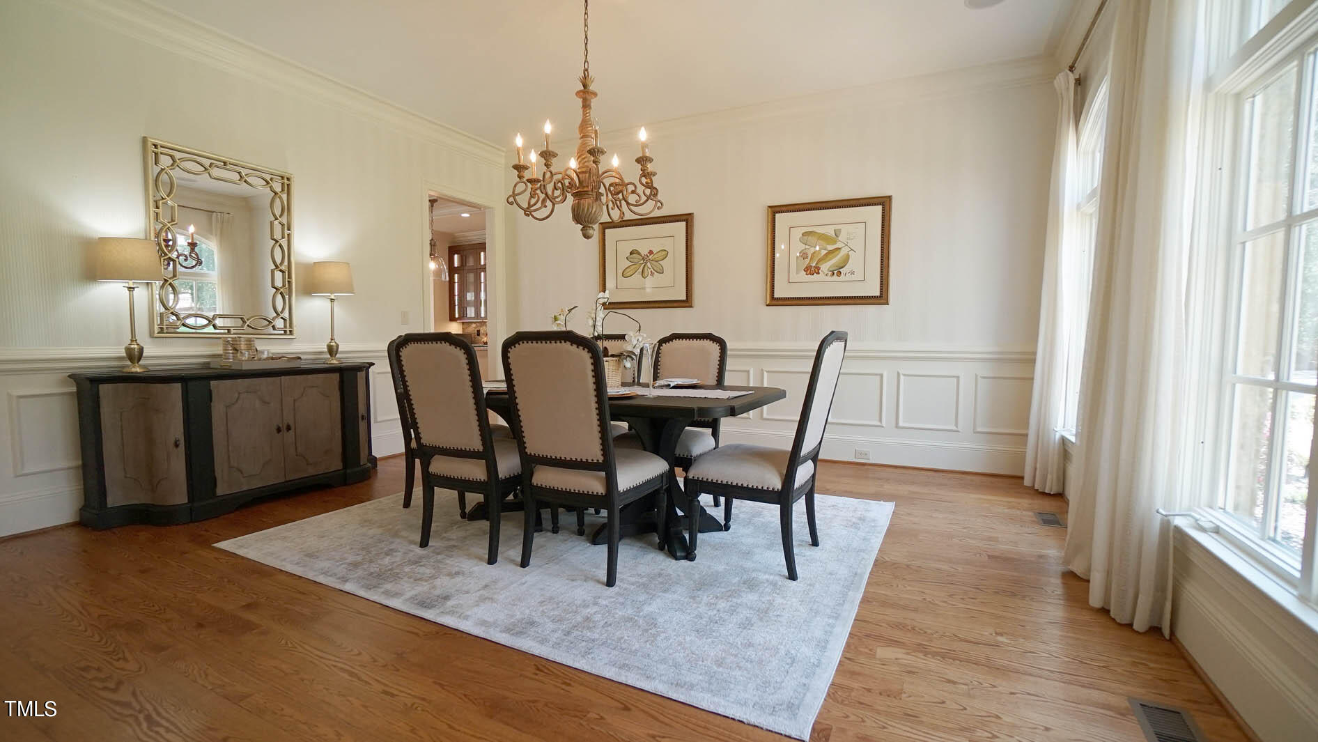 11216 Jonas Ridge Lane Raleigh, NC 27613 - Photo 16 of 75 a view of a dining room with furniture and chandelier