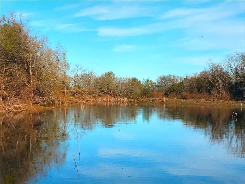 10521 Bitting School Road Manor, TX 78653 - Photo 9 of 13 Water view with a heavily wooded area