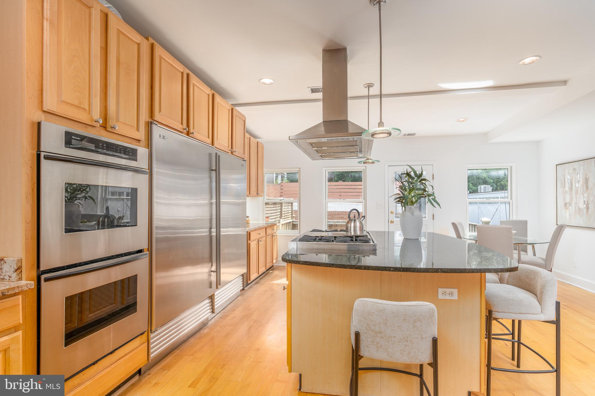 1683 35th Street Northwest, Unit A Washington, DC 20007 - Photo 11 of 26 a kitchen with kitchen island granite countertop a counter top space appliances and cabinets