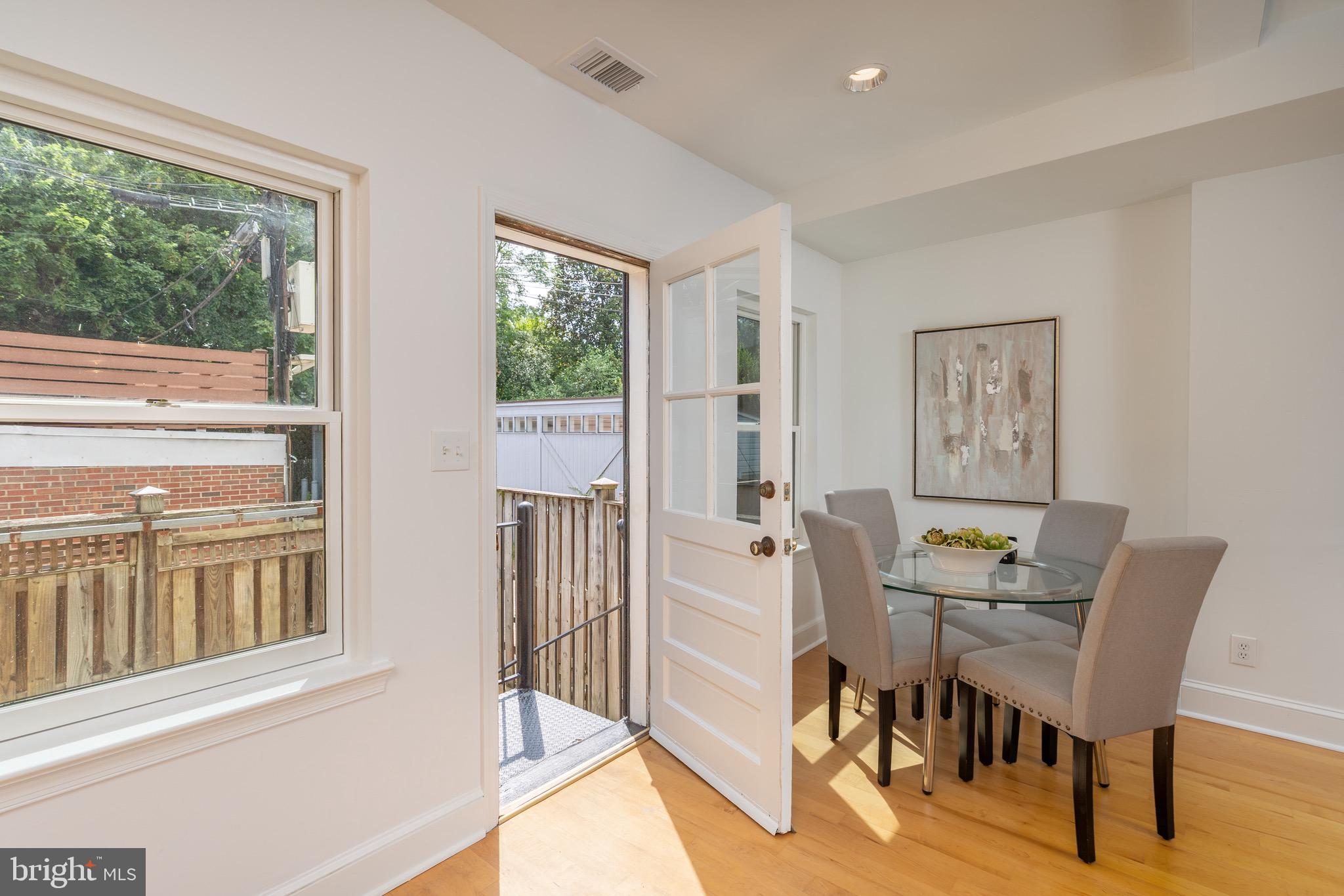 1683 35th Street Northwest, Unit A Washington, DC 20007 - Photo 13 of 26 a dining room with furniture and large windows