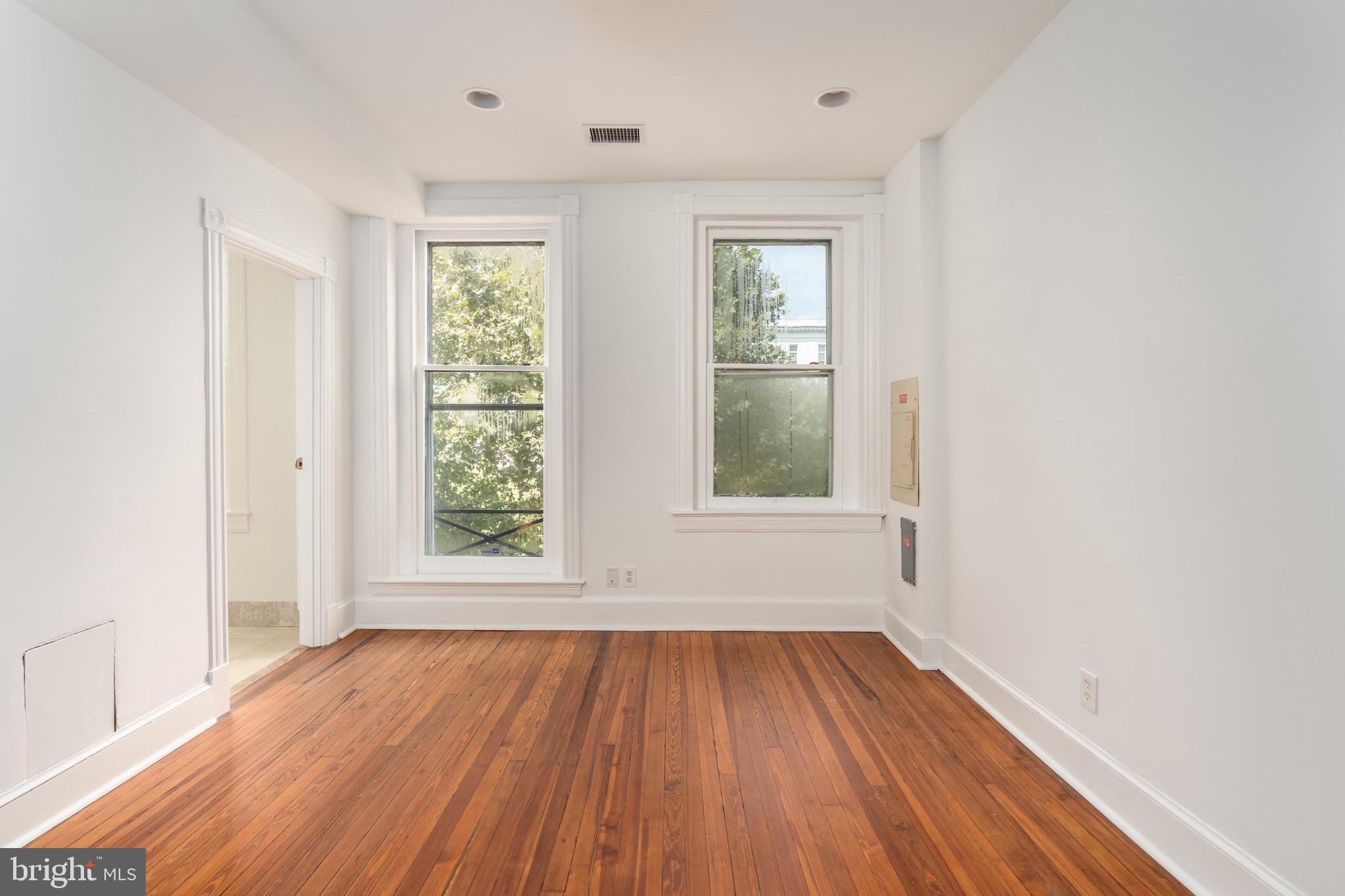 1683 35th Street Northwest, Unit A Washington, DC 20007 - Photo 20 of 26 an empty room with wooden floor and windows