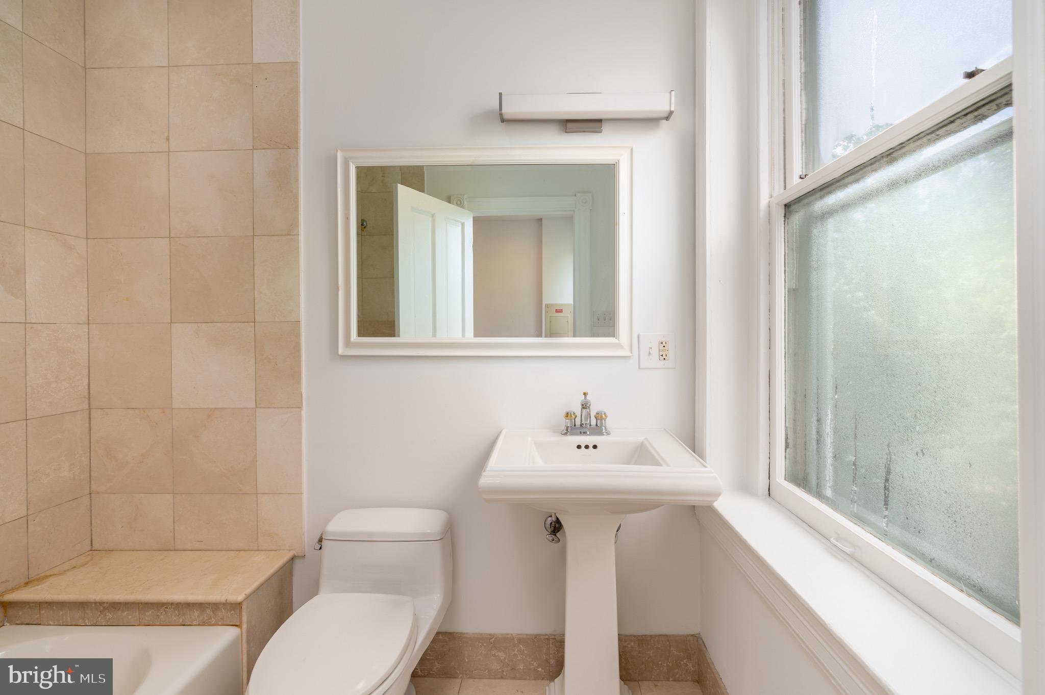 1683 35th Street Northwest, Unit A Washington, DC 20007 - Photo 21 of 26 a bathroom with a sink toilet and shower