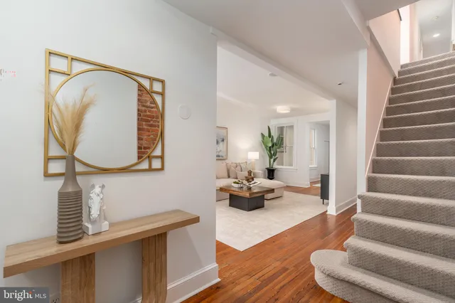 a view of living room with furniture and wooden floor