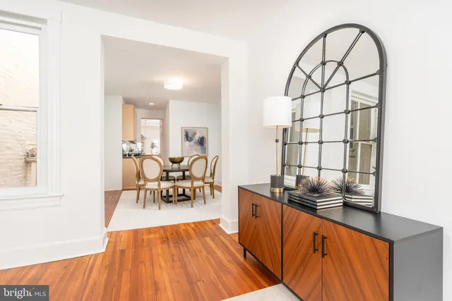 a living room with furniture a patio and a wooden floor
