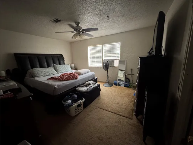 a bedroom with bed and a chandelier