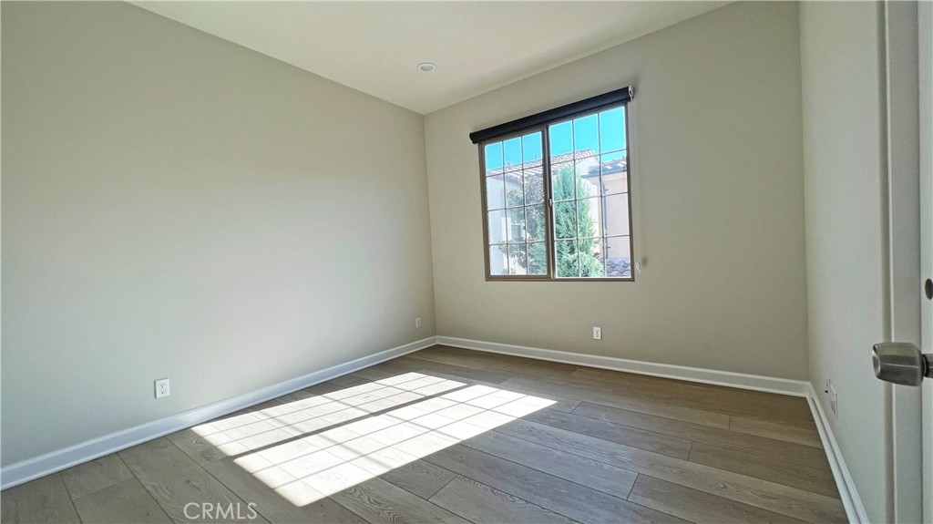 133 Copeland Irvine, CA 92618 - Photo 13 of 18 an empty room with wooden floor and windows