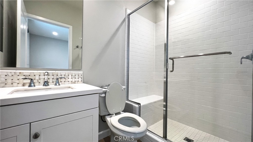 133 Copeland Irvine, CA 92618 - Photo 17 of 18 a bathroom with a toilet a sink and a mirror