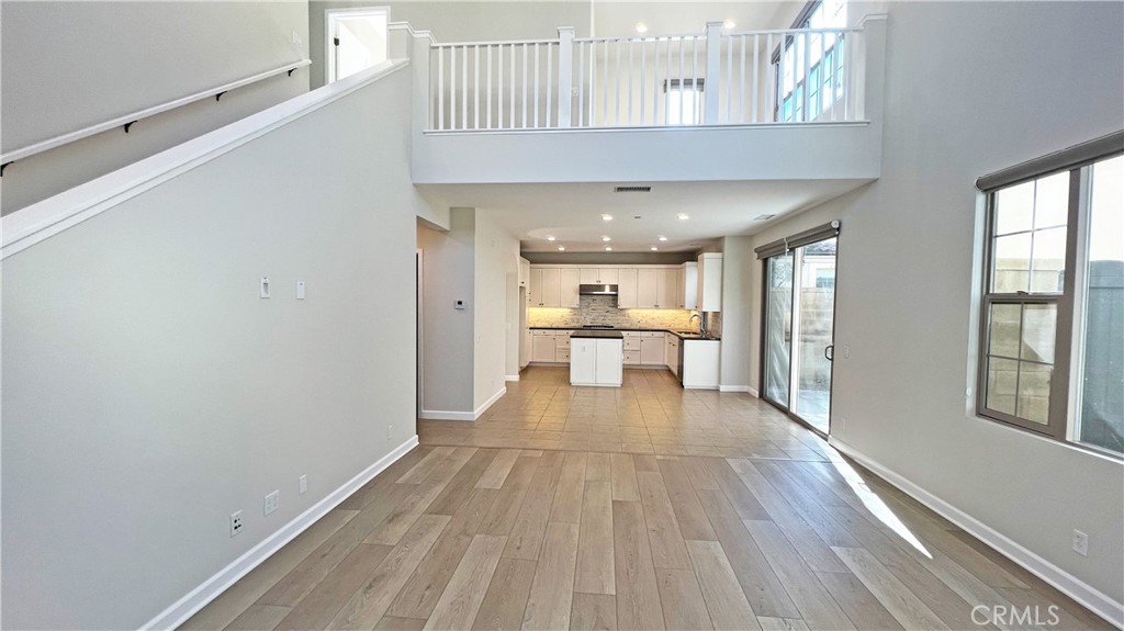 133 Copeland Irvine, CA 92618 - Photo 4 of 18 a view of a hallway with wooden floor and a bathroom