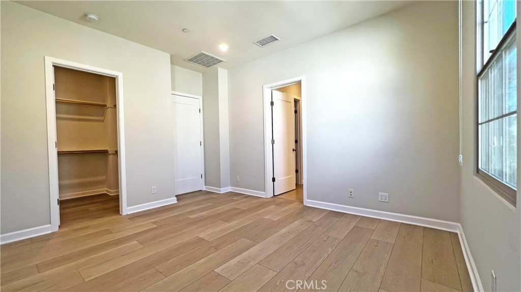 133 Copeland Irvine, CA 92618 - Photo 9 of 18 an empty room with wooden floor and windows