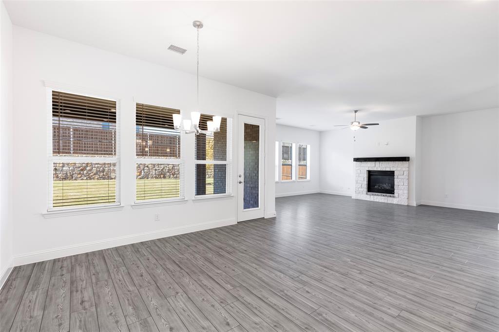 3207 Malcolm Road Melissa, TX 75454 - Photo 14 of 40 a view of an empty room with a window and wooden floor