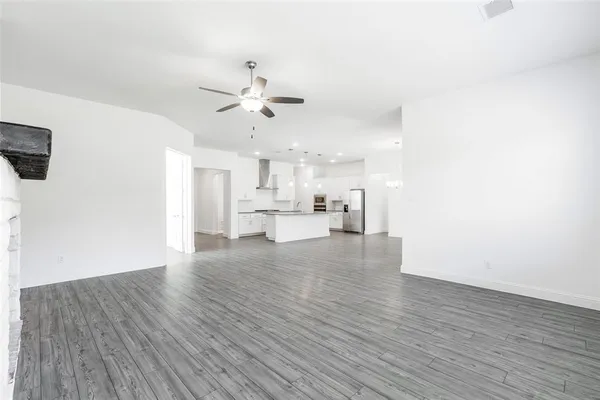 a view of kitchen with cabinets appliances and wooden floor