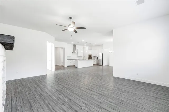 a view of kitchen with cabinets appliances and wooden floor