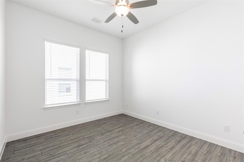 3207 Malcolm Road Melissa, TX 75454 - Photo 18 of 40 an empty room with wooden floor chandelier fan and window