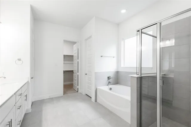 a bathroom with a bathtub and a sink