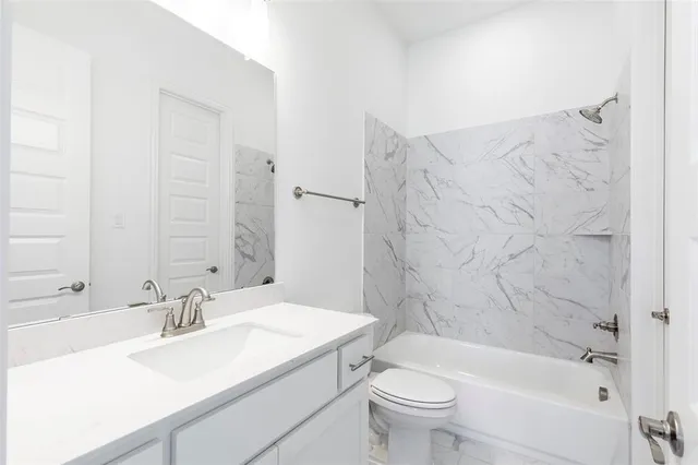 a bathroom with a sink a toilet and a bathtub