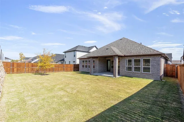 a front view of house with yard and patio