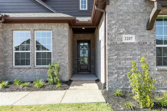 a front view of a brick house with a large windows