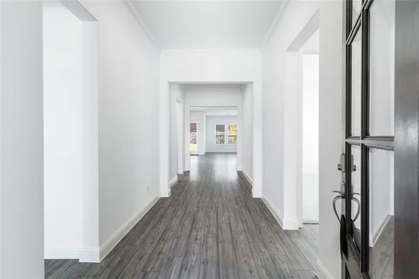 a view of a hallway with wooden floor