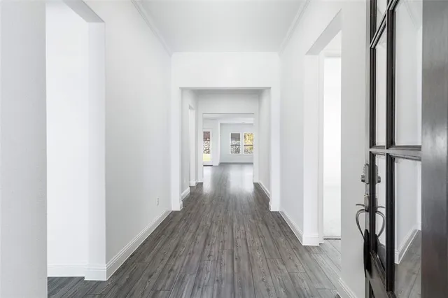 a view of a hallway with wooden floor