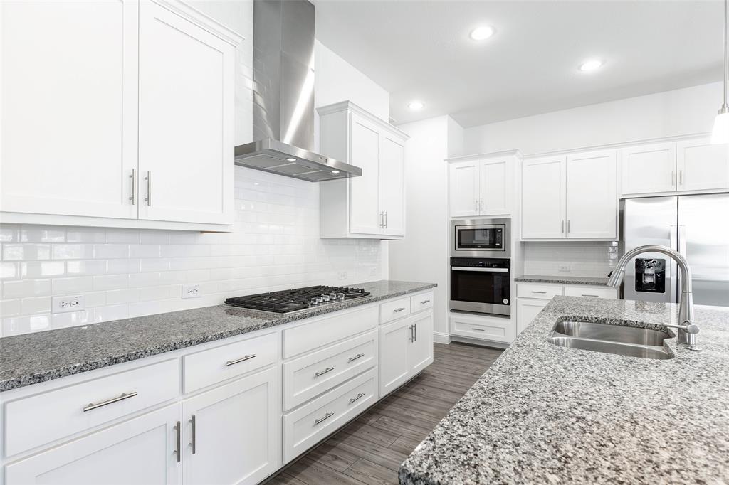 3207 Malcolm Road Melissa, TX 75454 - Photo 8 of 40 a kitchen with stainless steel appliances granite countertop a sink stove and cabinets